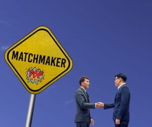 shaking hands near matchmaker sign symblising marketing to ideal customers